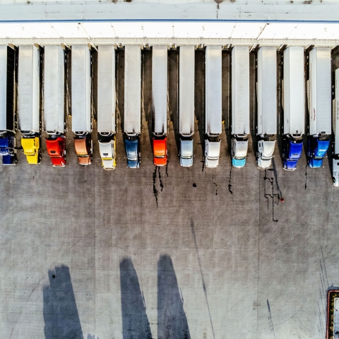 Fleet of temperature-controlled trucks docked at a Airsun Express cold storage warehouse facility.
